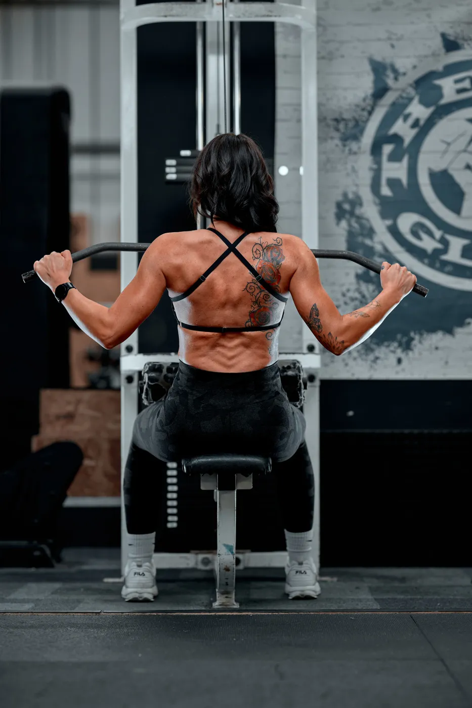 Holly on the lat pulldown machine, seen from behind